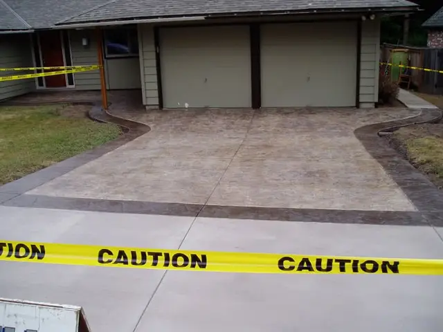 Freshly poured stamped concrete driveway with decorative border in Portland OR – Glorious Stone Construction